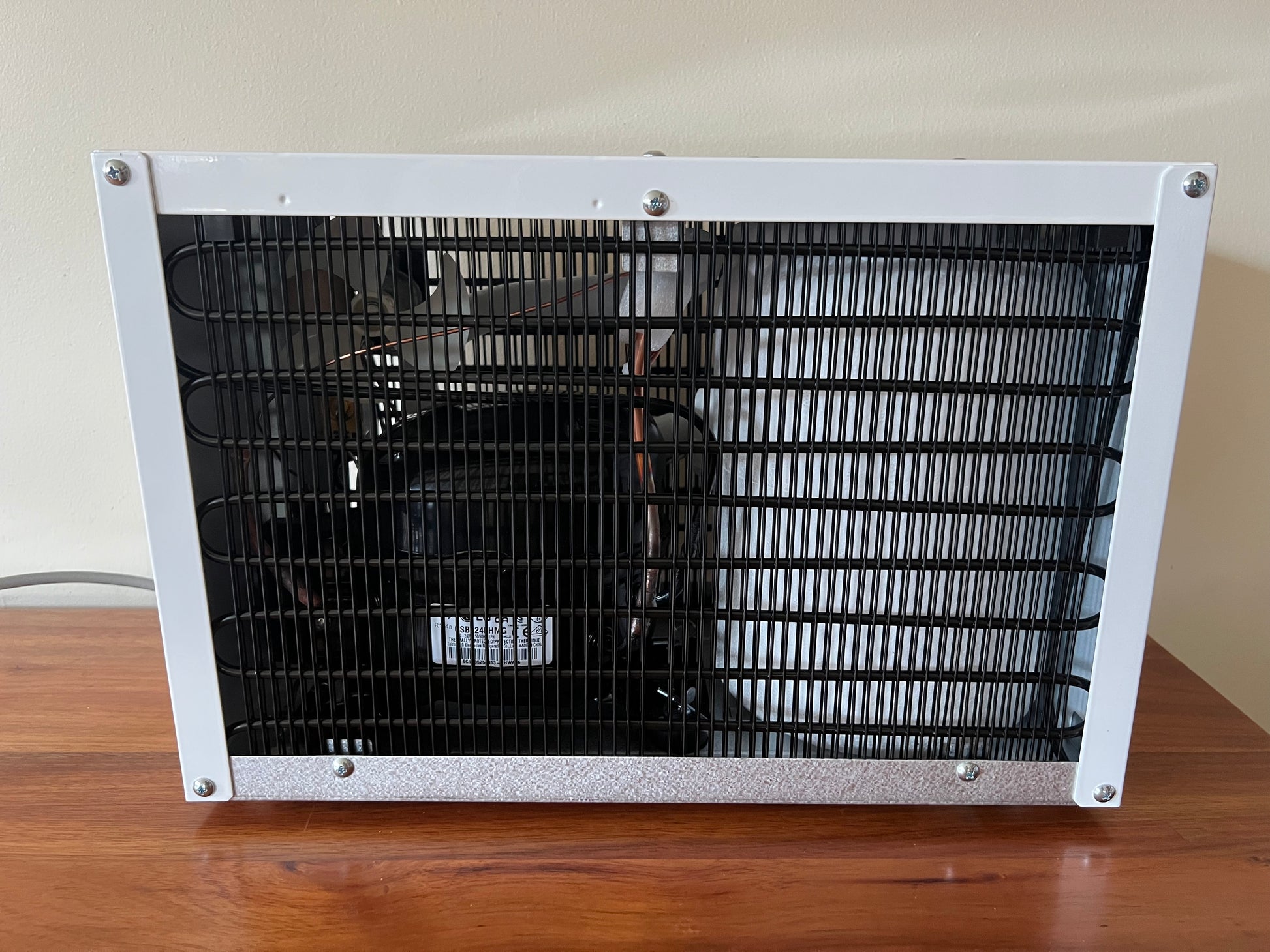 Compressor and fan behind the evaporator coil in the Waterworks IC8 under sink chiller
